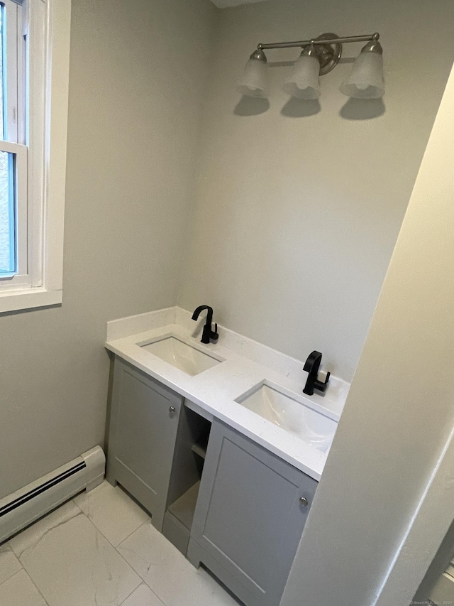 bathroom featuring a baseboard heating unit and vanity