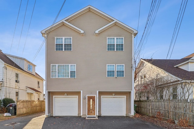 rear view of property featuring a garage