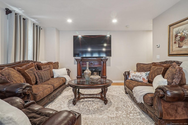 living room with light hardwood / wood-style floors and a fireplace