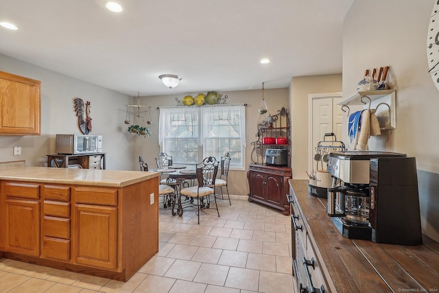 kitchen featuring kitchen peninsula and light tile patterned flooring