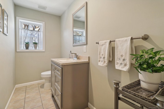 bathroom featuring tile patterned flooring, vanity, and toilet