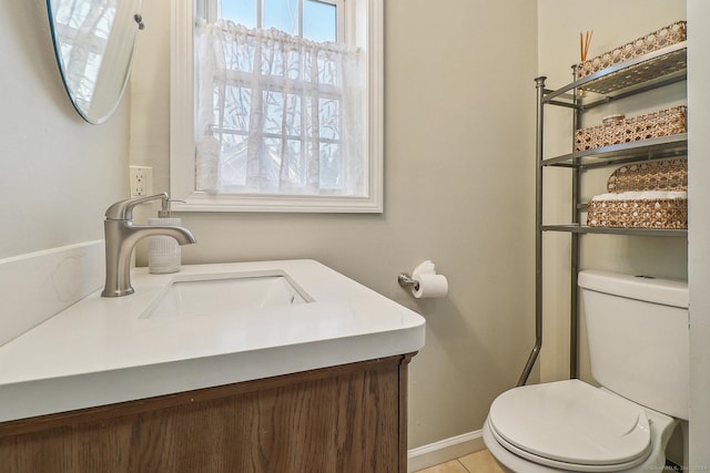 bathroom featuring toilet, vanity, and tile patterned floors