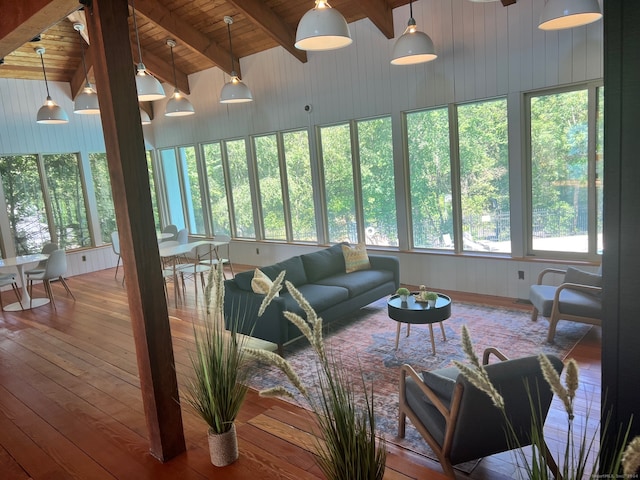 sunroom / solarium featuring lofted ceiling with beams, a healthy amount of sunlight, and wooden ceiling