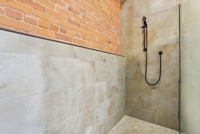 interior details featuring tiled shower