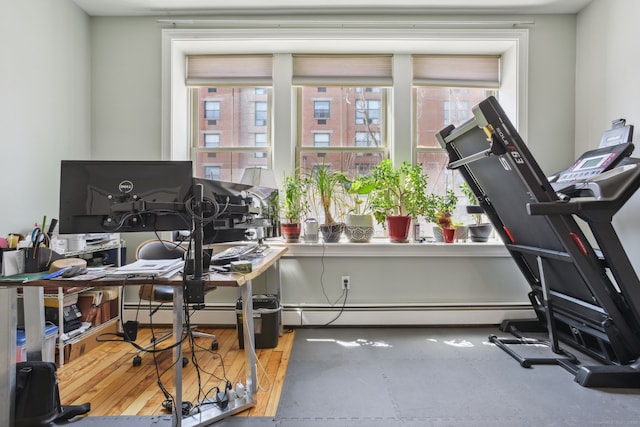 office with wood-type flooring and baseboard heating