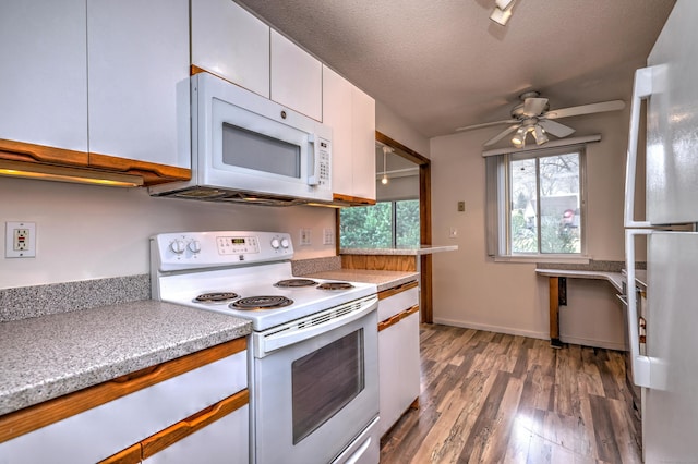 kitchen featuring white appliances, dark wood-type flooring, ceiling fan, a textured ceiling, and white cabinetry