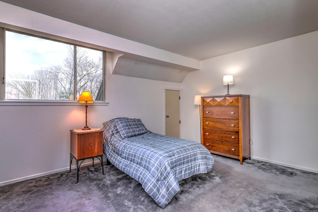 carpeted bedroom with lofted ceiling and a textured ceiling