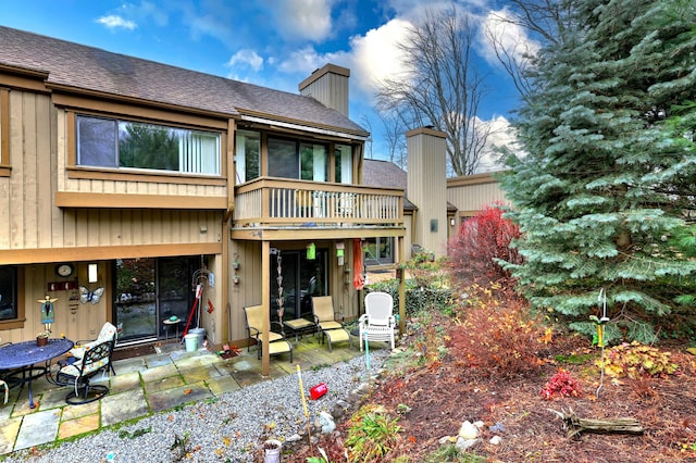 back of house featuring a patio area and a balcony