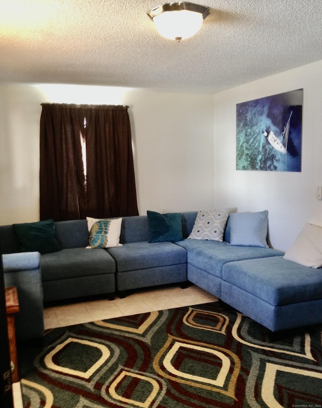 living room featuring light tile patterned floors and a textured ceiling