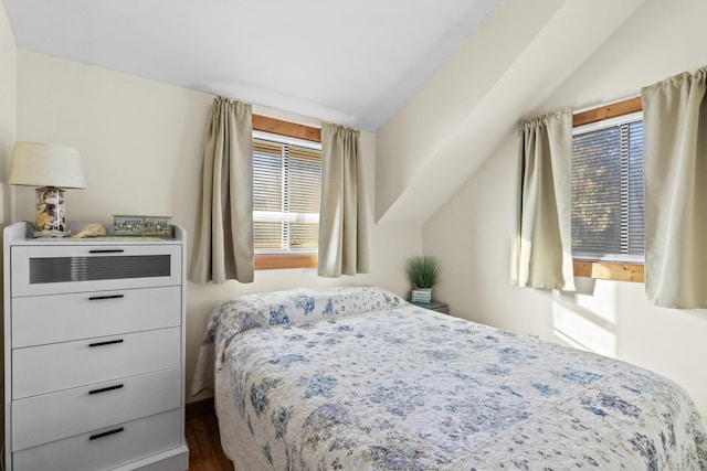 bedroom featuring hardwood / wood-style floors and lofted ceiling