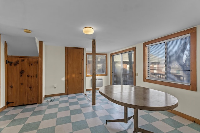 unfurnished dining area featuring a wall mounted air conditioner