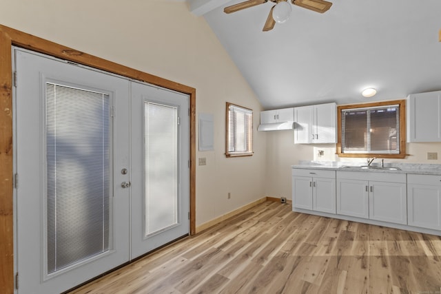 kitchen featuring light wood-type flooring, lofted ceiling with beams, white cabinetry, and ceiling fan