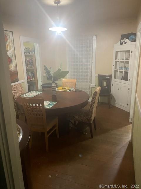 dining area featuring dark wood-type flooring