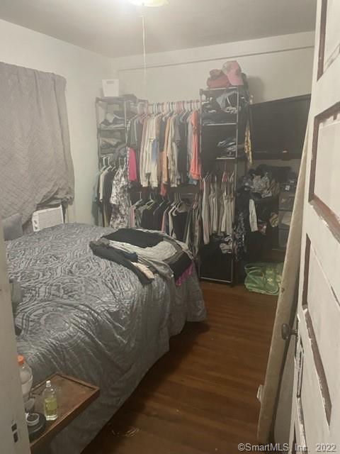 bedroom featuring dark hardwood / wood-style flooring and a closet