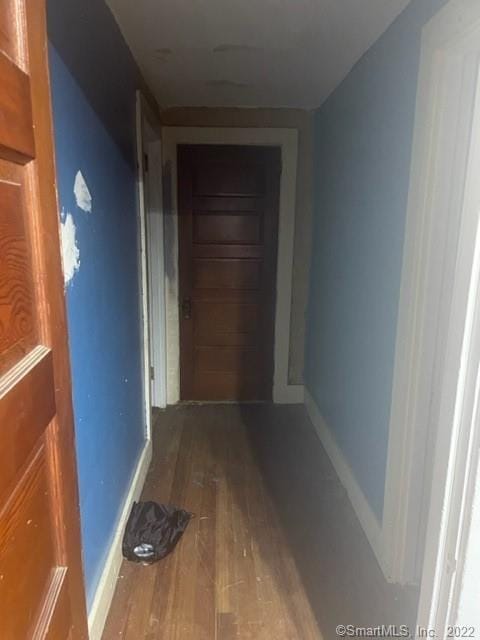 hallway with hardwood / wood-style floors