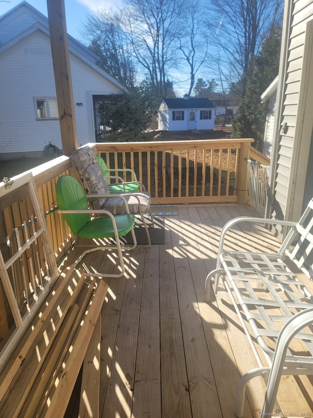 wooden terrace featuring an outdoor structure