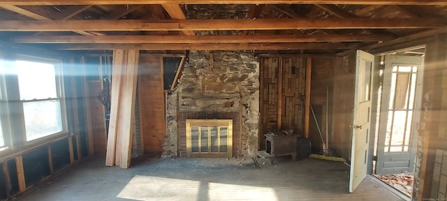 miscellaneous room featuring a stone fireplace and a wealth of natural light