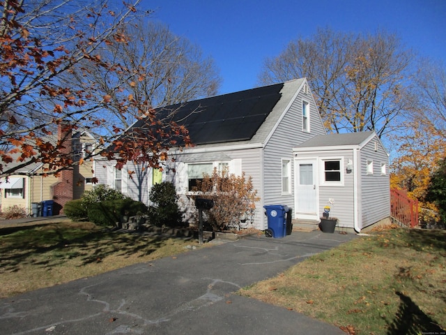 exterior space with a front yard and solar panels