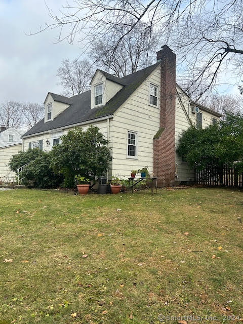 view of property exterior with a yard