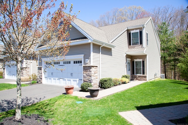 view of front of home featuring a front yard and a garage