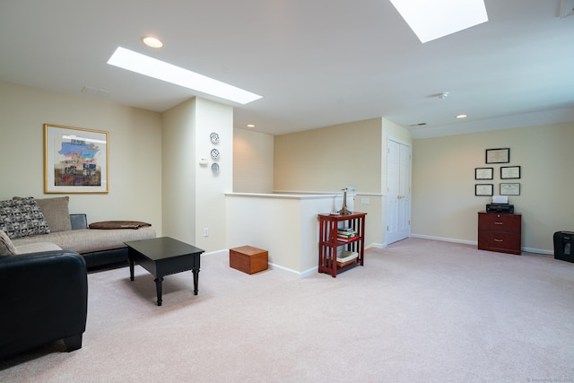 living room featuring light carpet and a skylight