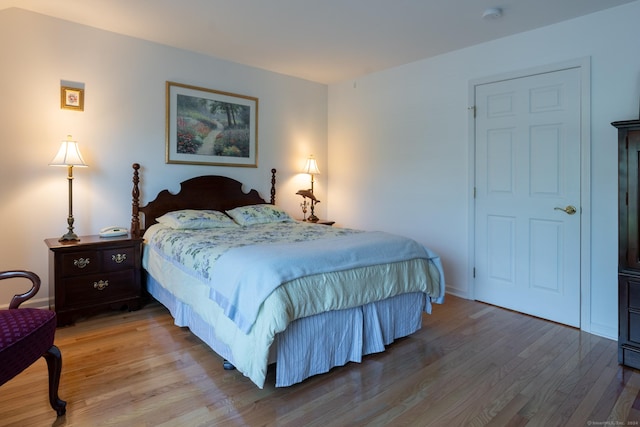 bedroom with hardwood / wood-style flooring