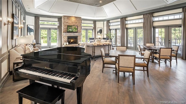 misc room with a fireplace, crown molding, french doors, and dark wood-type flooring