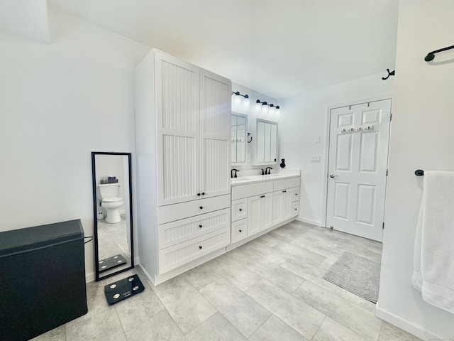 bathroom featuring vanity and toilet