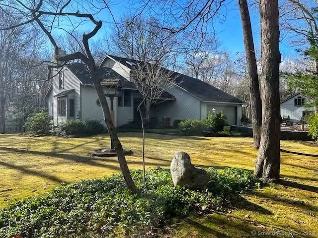 view of property exterior with a yard