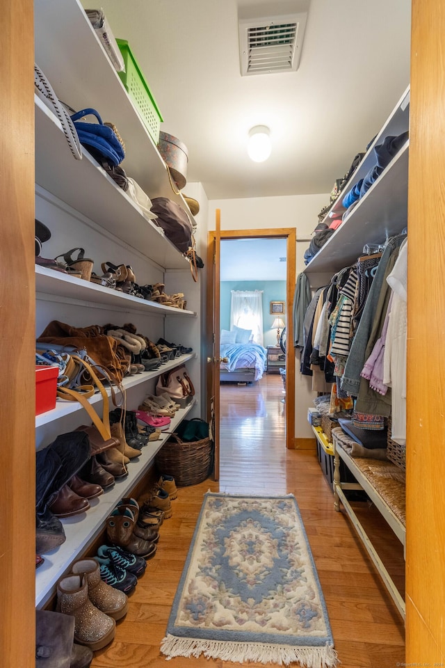 walk in closet featuring light hardwood / wood-style flooring