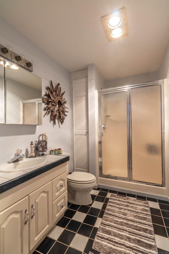 bathroom with vanity, toilet, and walk in shower