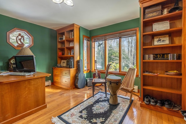 office featuring light wood-type flooring and baseboard heating