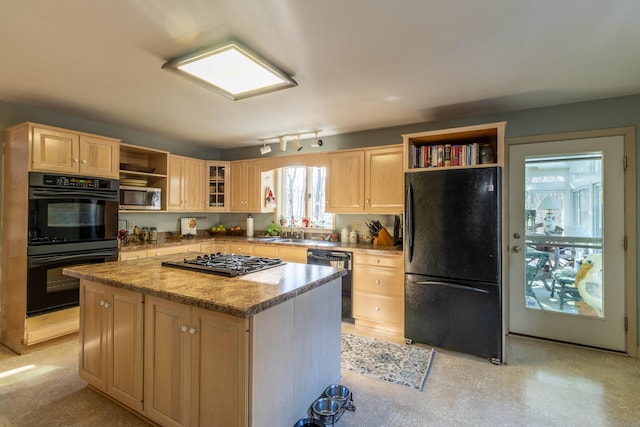 kitchen featuring light brown cabinetry, light stone countertops, a center island, and black appliances