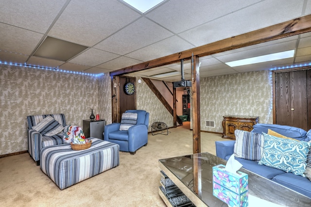 basement featuring carpet and a drop ceiling