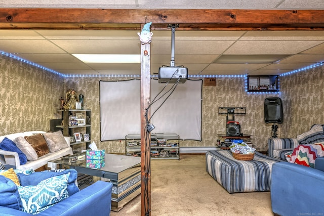 basement with carpet flooring, a paneled ceiling, and baseboard heating