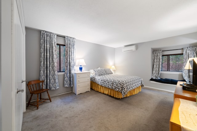 carpeted bedroom with a wall mounted AC