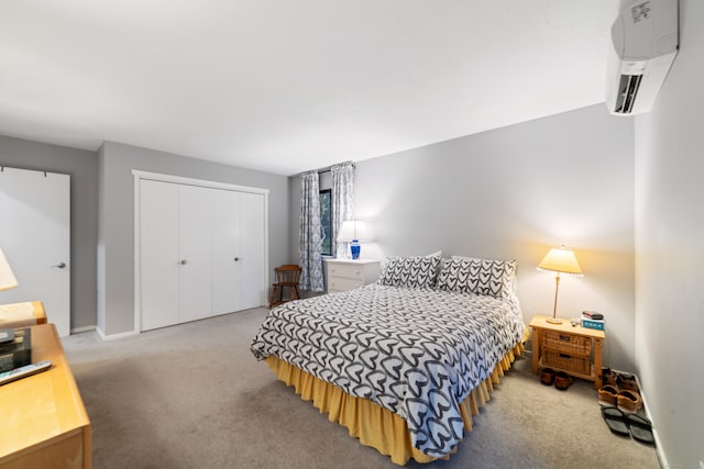 carpeted bedroom with a wall mounted AC and a closet