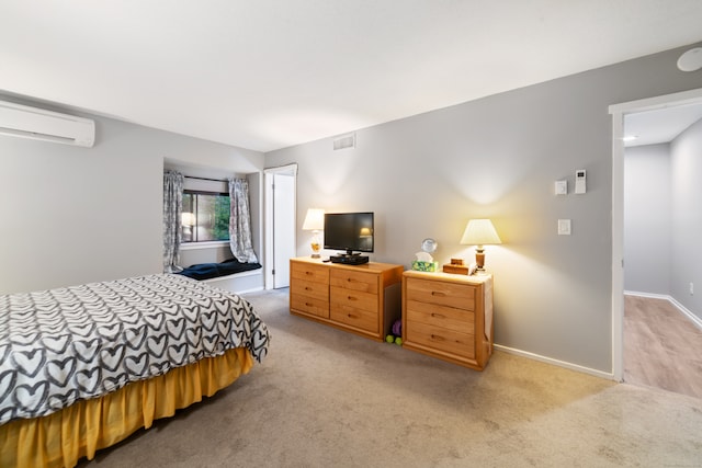 carpeted bedroom with an AC wall unit