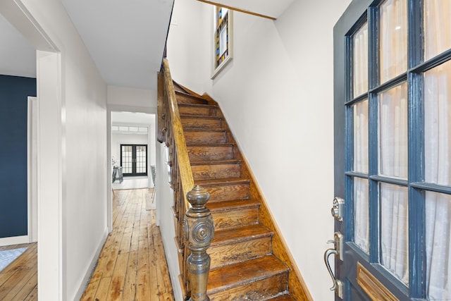 stairs with hardwood / wood-style floors