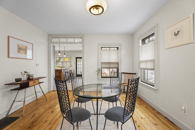 dining area featuring a wealth of natural light and light hardwood / wood-style flooring