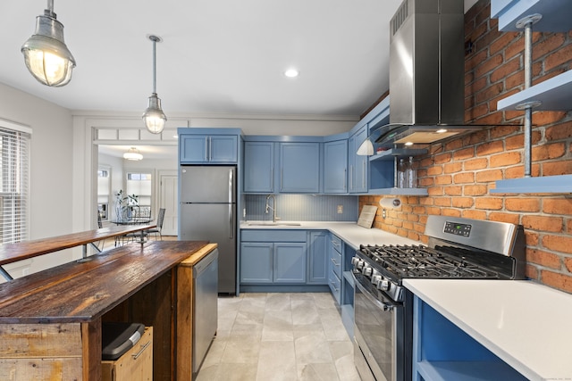 kitchen with decorative backsplash, appliances with stainless steel finishes, blue cabinets, and sink