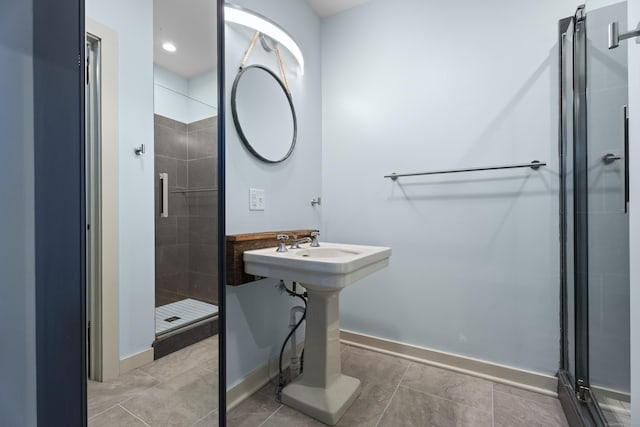 bathroom with an enclosed shower and sink