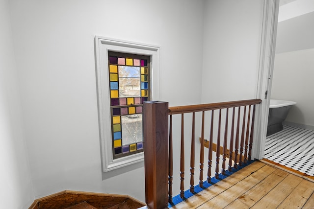 stairway featuring wood-type flooring