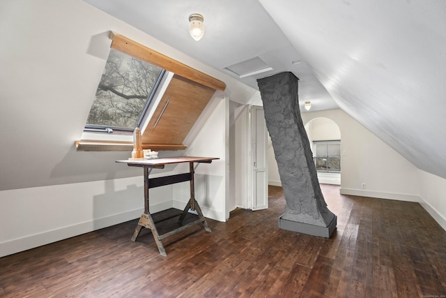 additional living space with dark wood-type flooring and vaulted ceiling