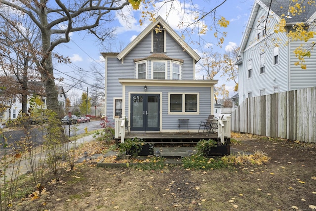 rear view of property featuring french doors and a deck