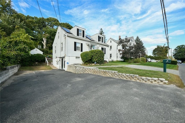 view of side of property with a lawn