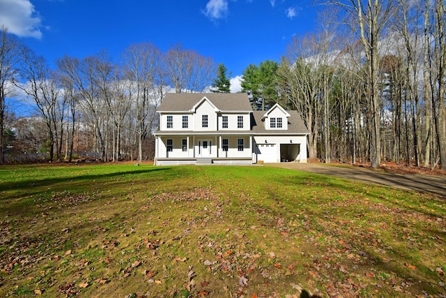 view of front of house with a front lawn, covered porch, and a garage