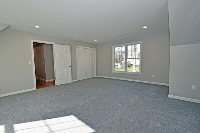 unfurnished bedroom with dark colored carpet