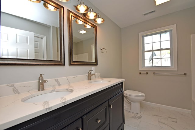 bathroom featuring vanity and toilet