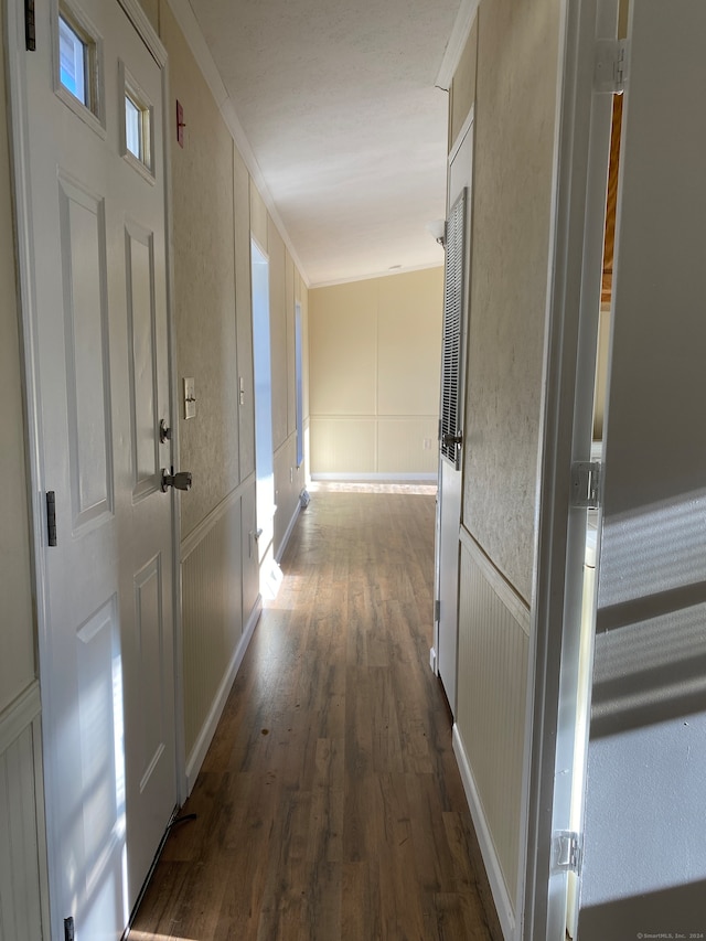 hall featuring crown molding and dark hardwood / wood-style flooring